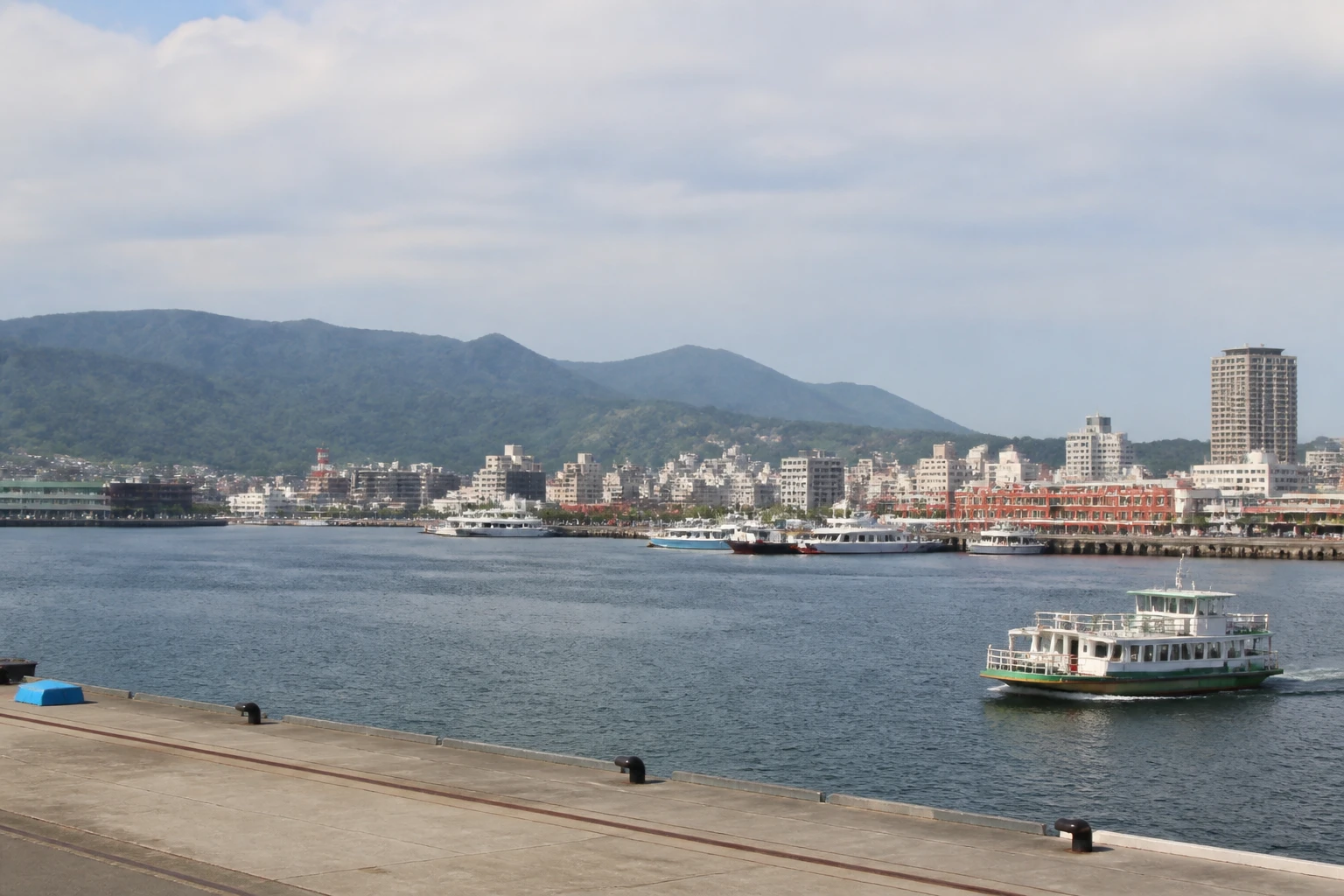 Representative cruise port destination view: Kochi, Japan; passenger waterfront and harbor water, not an exact landmark photograph.