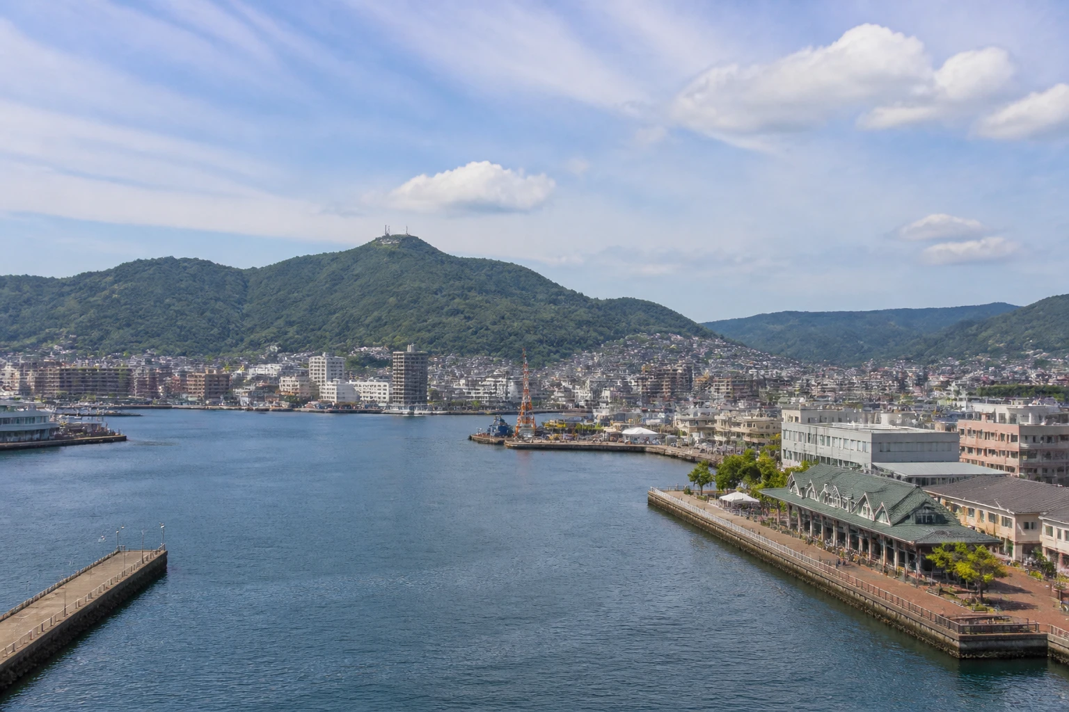 Representative cruise port destination view: Sasebo, Japan; passenger waterfront and harbor water, not an exact landmark photograph.