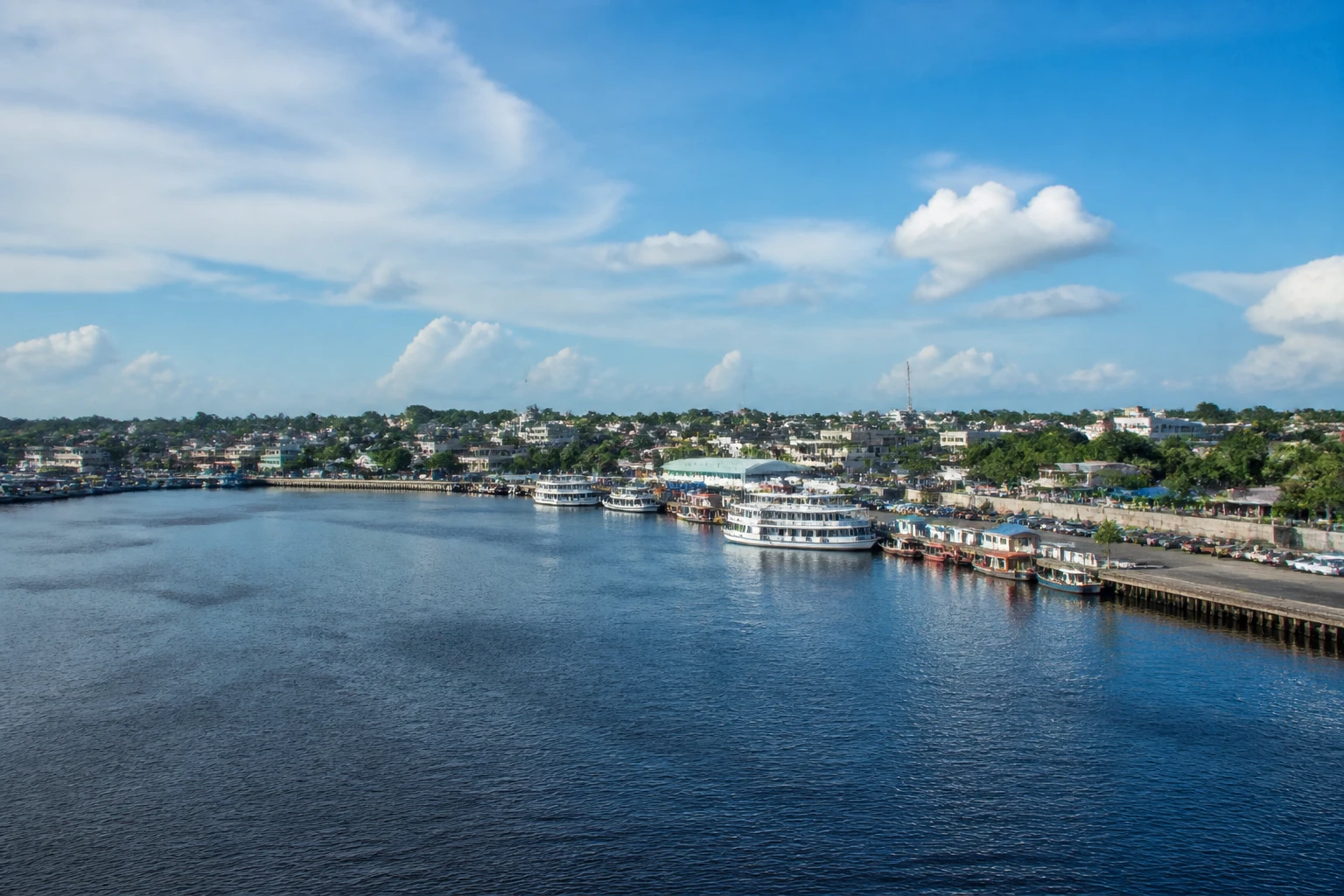 Representative cruise port destination view: Parintins, Brazil; passenger waterfront and harbor water, not an exact landmark photograph.