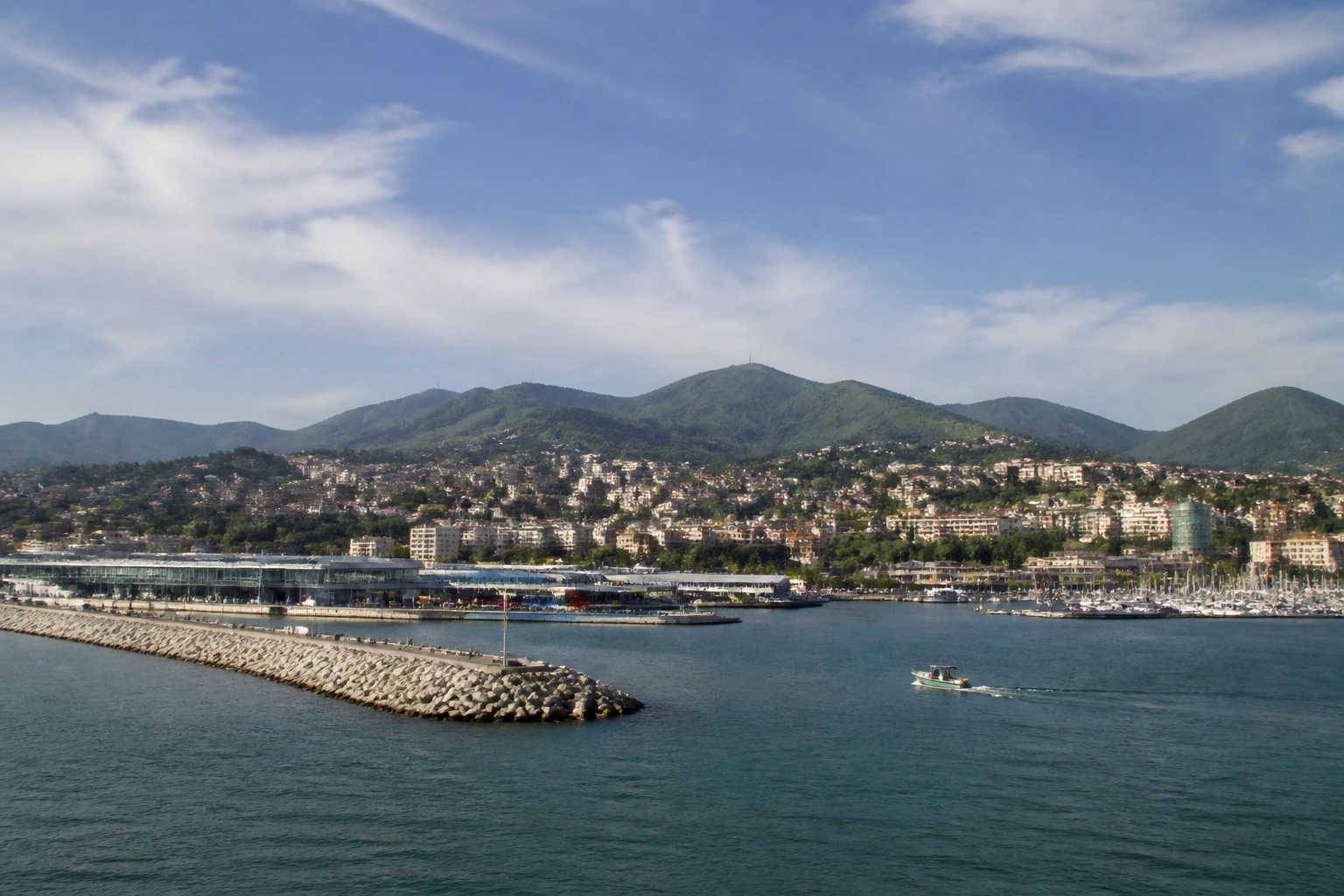 Representative cruise port destination view: La Spezia, Italy; passenger waterfront and harbor water, not an exact landmark photograph.