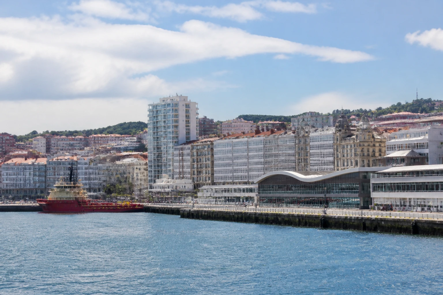 Representative cruise port destination view: A Coruña, Spain; passenger waterfront and harbor water, not an exact landmark photograph.