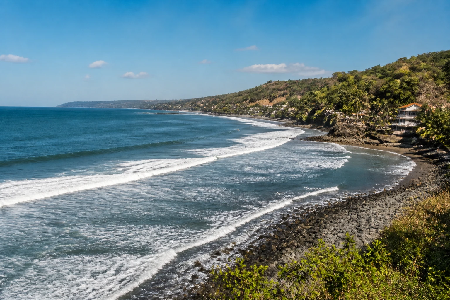 Representative coastal destination view: El Salvador Surf Coast; coastline and regional vegetation, not an exact landmark photograph.