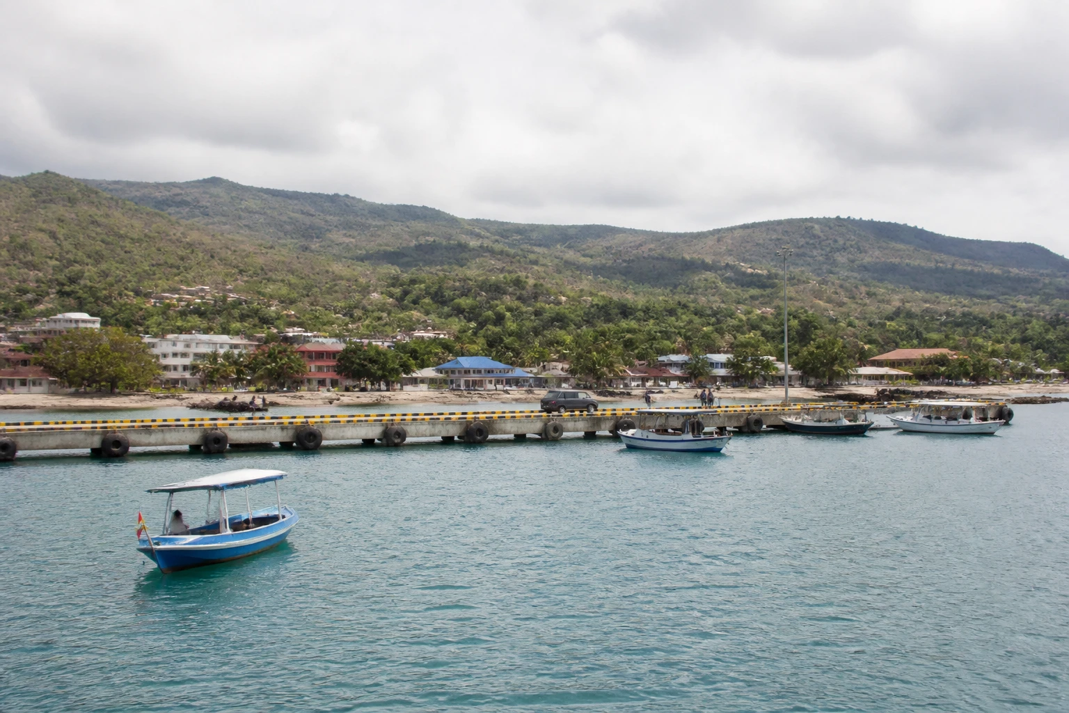 Representative cruise port destination view: Waingapu, Indonesia; passenger waterfront and harbor water, not an exact landmark photograph.