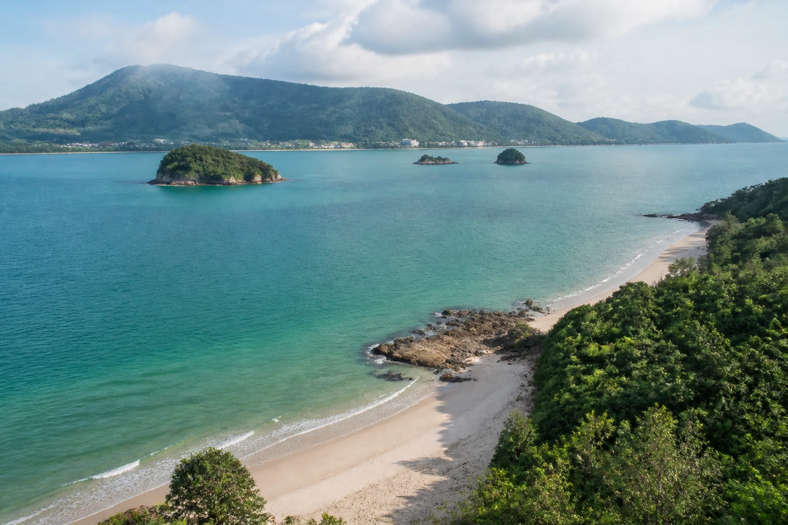 Representative island destination view: Langkawi, Malaysia; coastline and regional vegetation, not an exact landmark photograph.