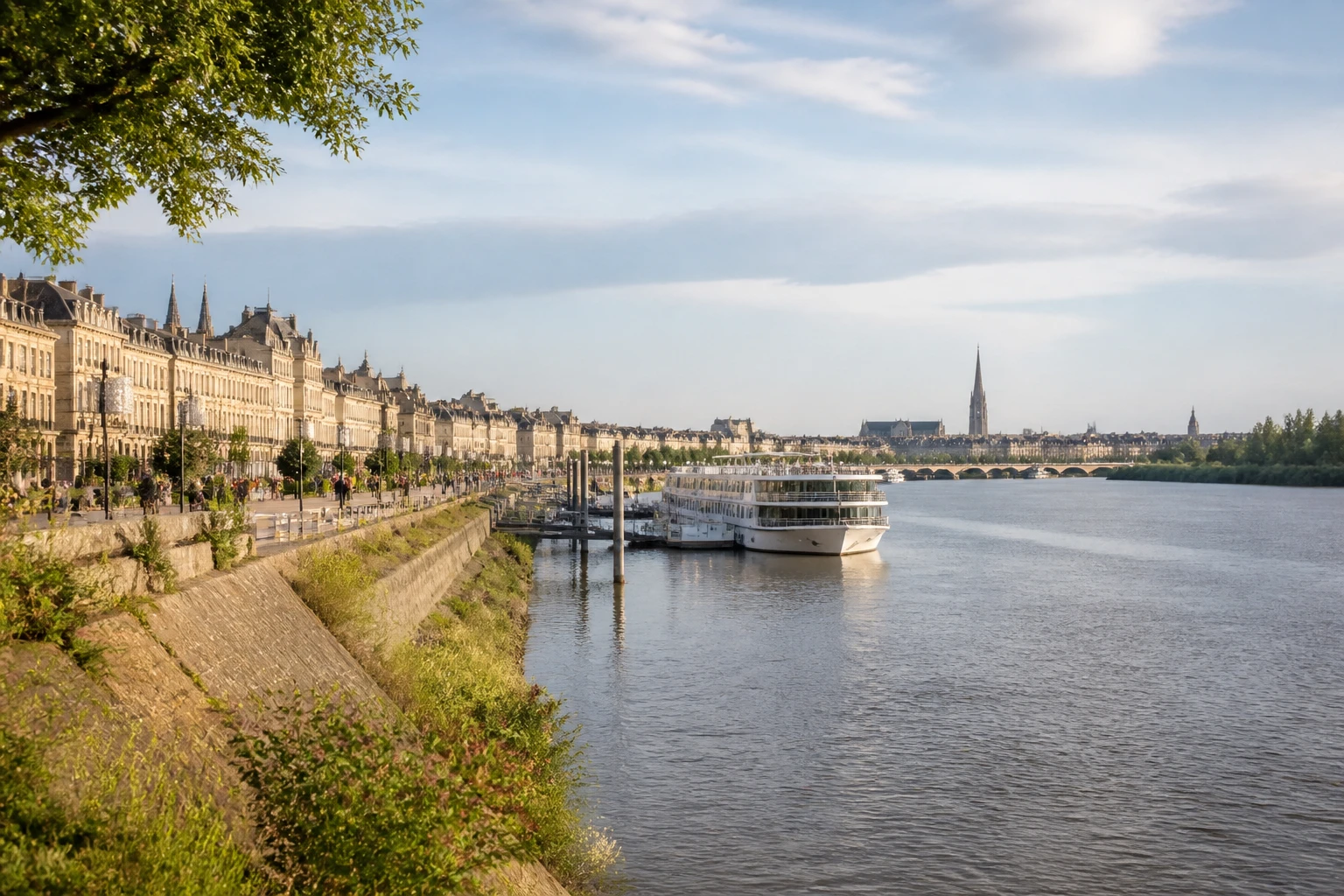 Representative river destination view: Bordeaux, France; inland water, regional terrain, and vegetation, not an exact landmark photograph.