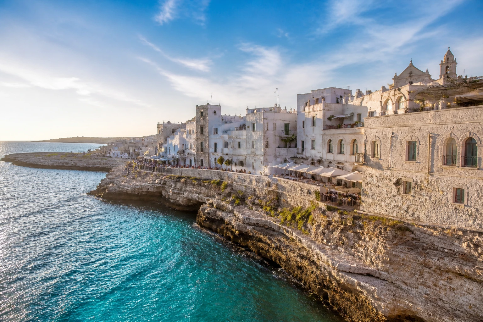 Representative coastal destination view: Puglia, Italy; coastline and regional vegetation, not an exact landmark photograph.