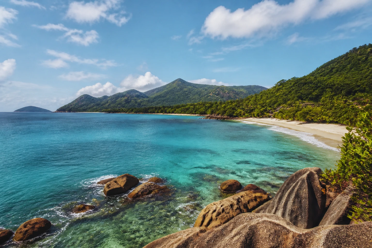Representative island destination view: Seychelles; coastline and regional vegetation, not an exact landmark photograph.
