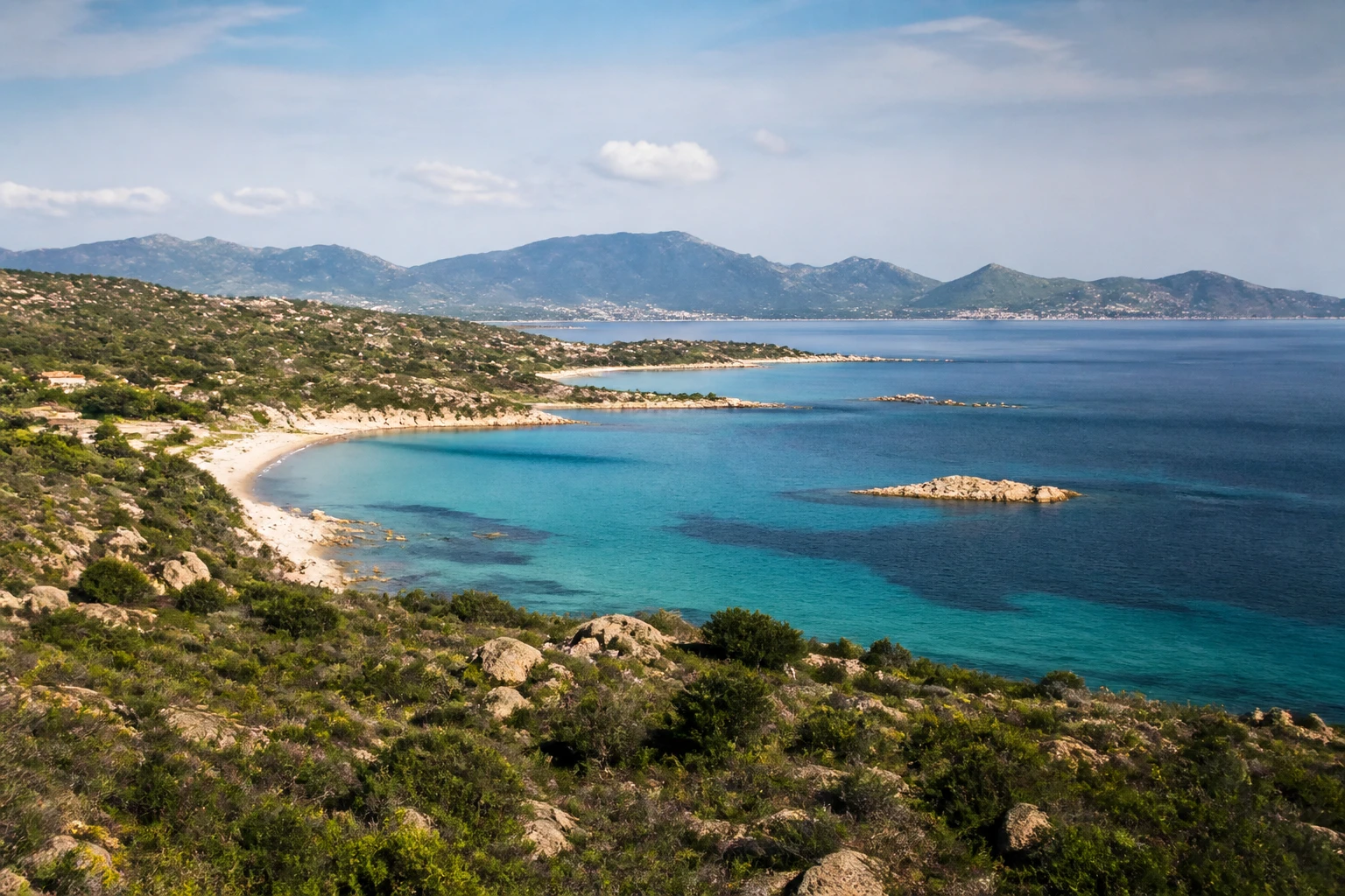 Representative island destination view: Sardinia, Italy; coastline and regional vegetation, not an exact landmark photograph.