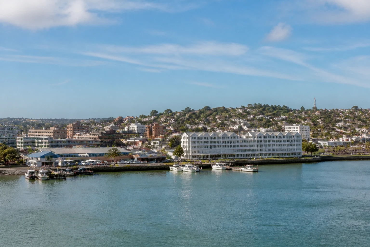 Representative cruise port destination view: East London, South Africa; passenger waterfront and harbor water, not an exact landmark photograph.