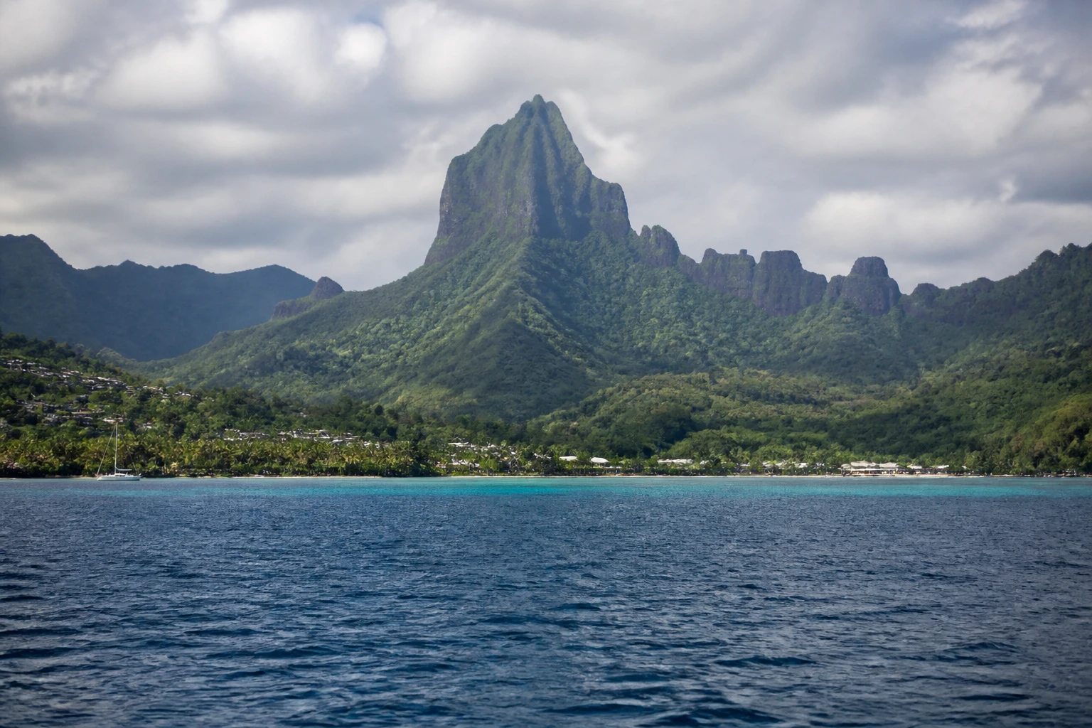 Representative island destination view: Moorea, French Polynesia; coastline and regional vegetation, not an exact landmark photograph.