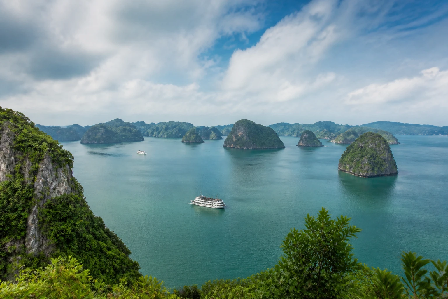 Representative nature destination view of Ha Long Bay in Vietnam, with regional terrain, vegetation, and natural light; not an exact landmark photograph.