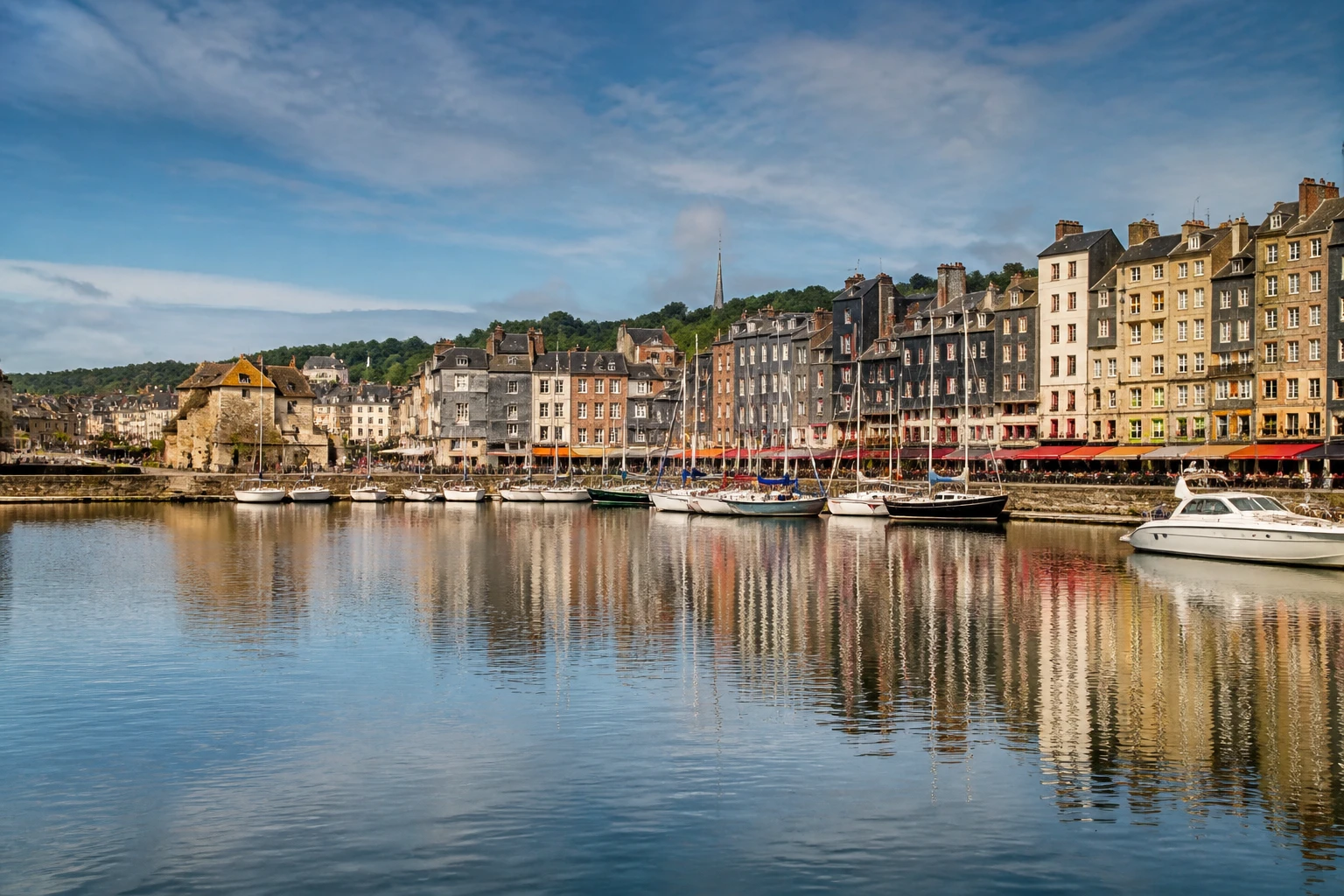 Representative cruise port destination view: Honfleur, France; passenger waterfront and harbor water, not an exact landmark photograph.