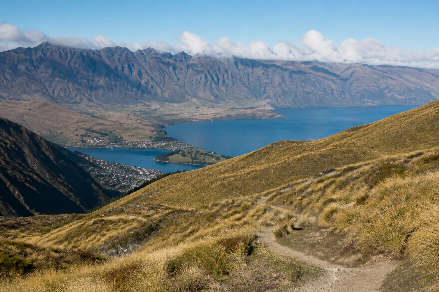 Representative mountain destination view: Queenstown, New Zealand; mountain or canyon terrain and regional vegetation, not an exact landmark photograph.