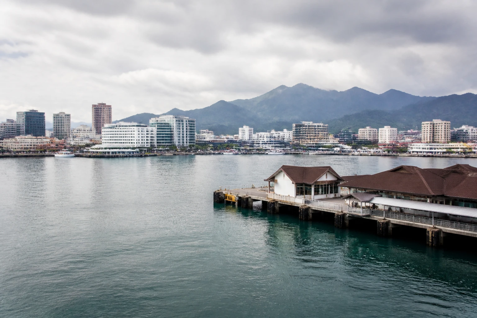 Representative cruise port destination view: Kota Kinabalu, Malaysia; passenger waterfront and harbor water, not an exact landmark photograph.