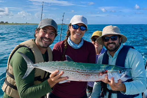 Group of anglers displaying a large mackerel during a Costa Maya fishing charter