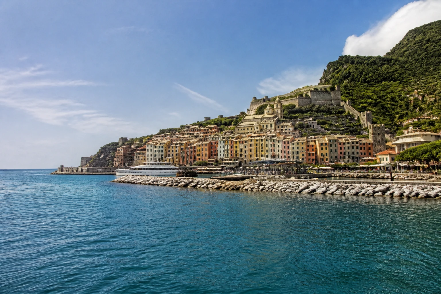 Representative cruise port destination view: Portovenere, Italy; passenger waterfront and harbor water, not an exact landmark photograph.