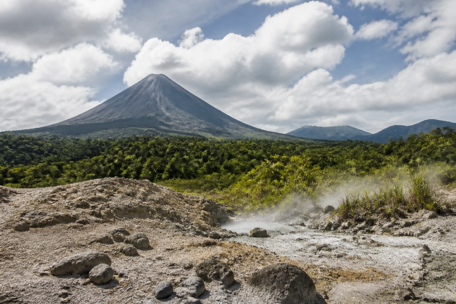 Representative nature destination view: Arenal and La Fortuna, Costa Rica; mineral earth, rock, and regional vegetation, not an exact landmark photograph.