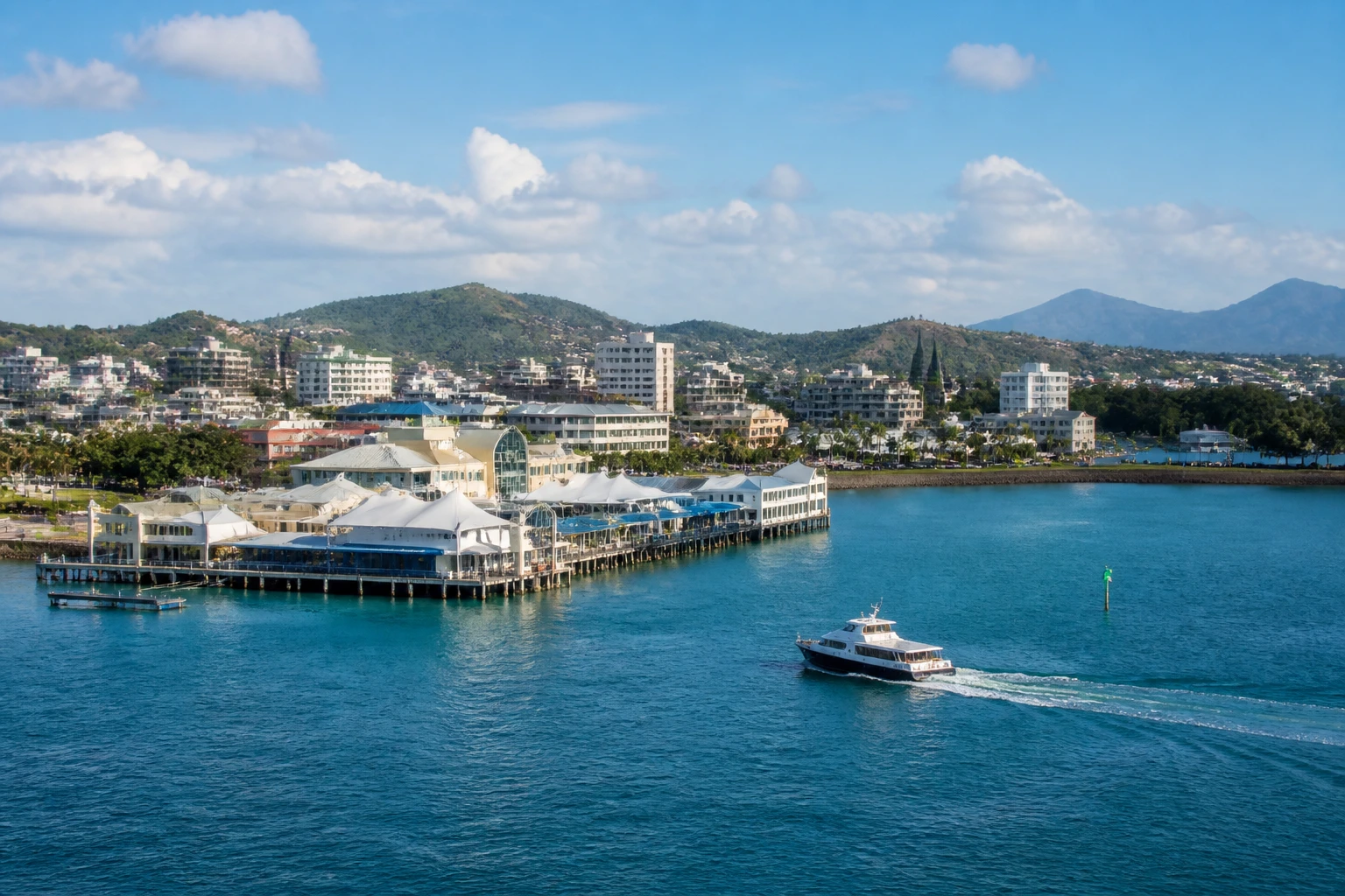 Representative cruise port destination view: Noumea, New Caledonia; passenger waterfront and harbor water, not an exact landmark photograph.