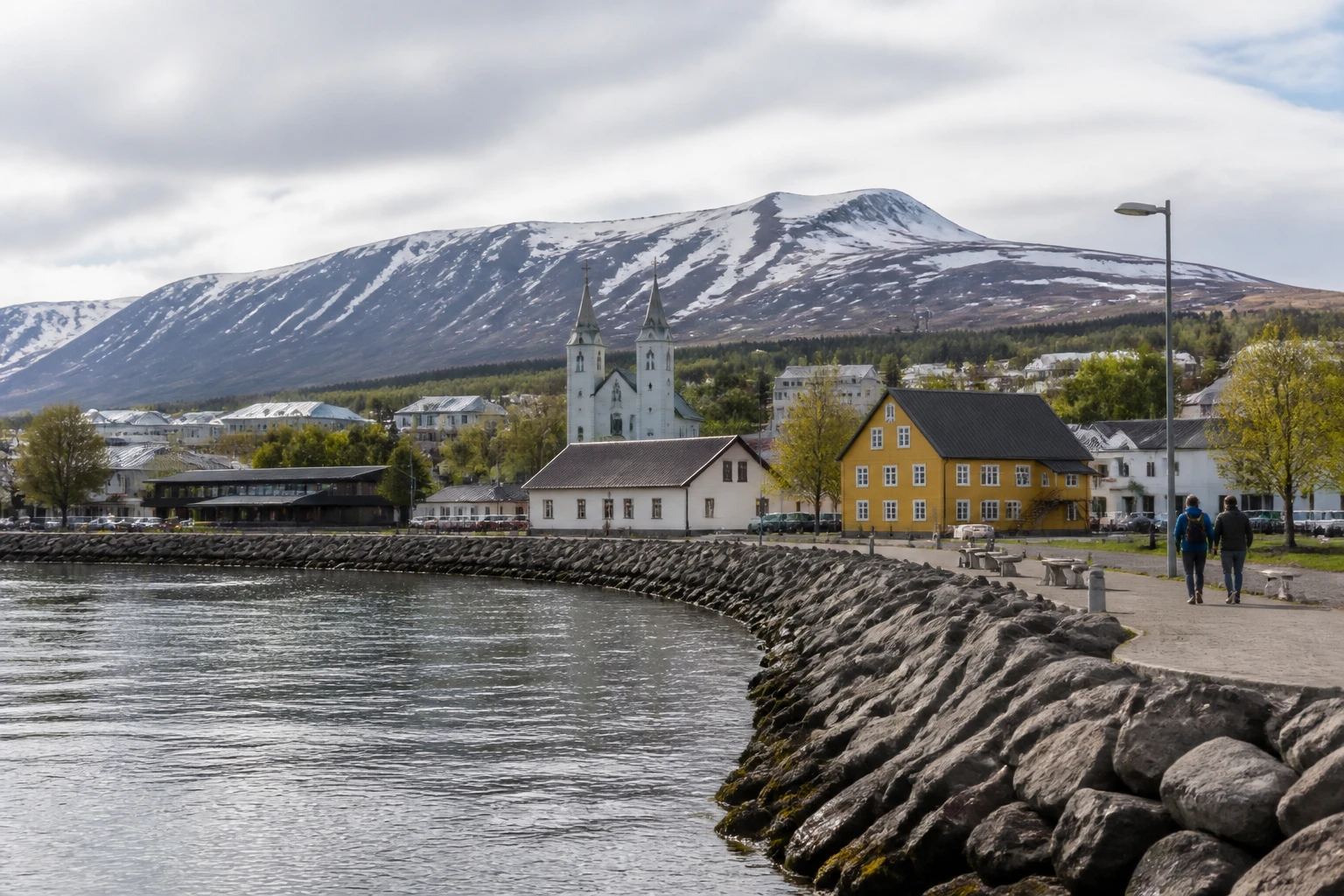 Representative city destination view: Akureyri, Iceland; passenger waterfront and harbor water, not an exact landmark photograph.