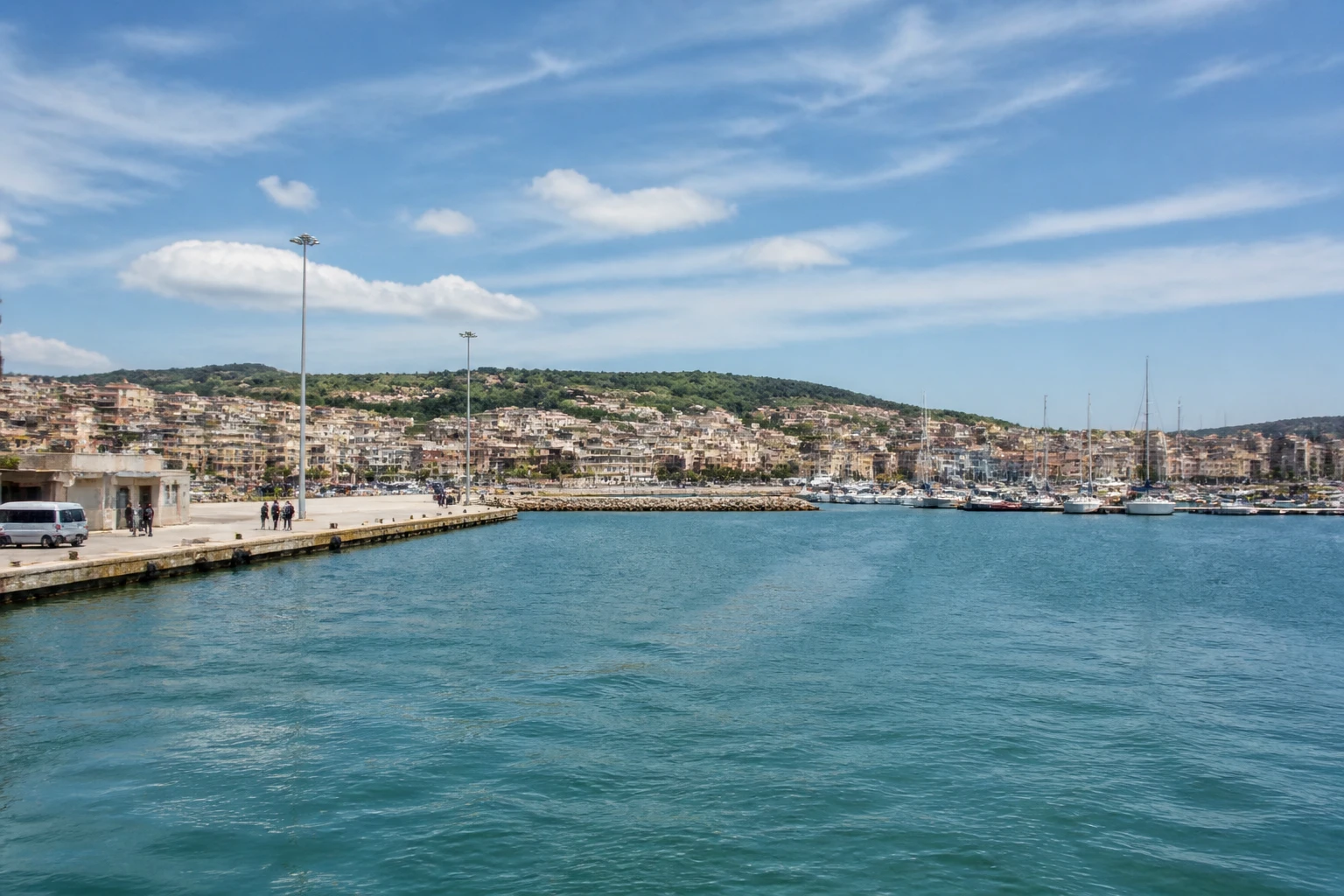Representative cruise port destination view: Crotone, Italy; passenger waterfront and harbor water, not an exact landmark photograph.