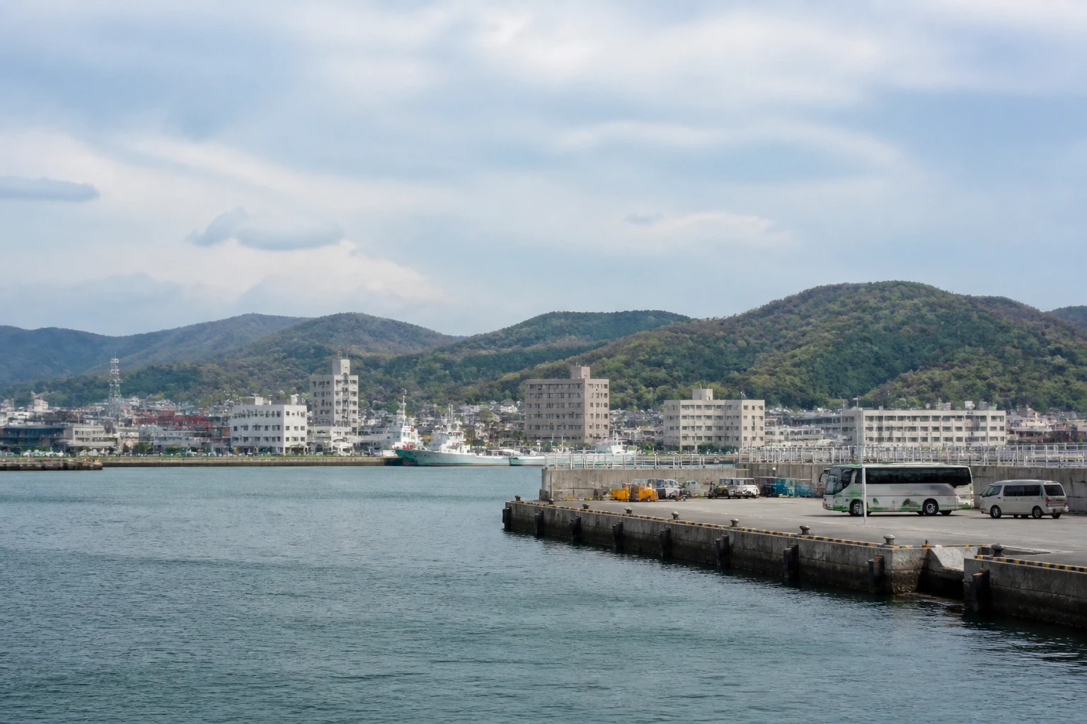 Representative cruise port destination view: Ishinomaki, Japan; passenger waterfront and harbor water, not an exact landmark photograph.
