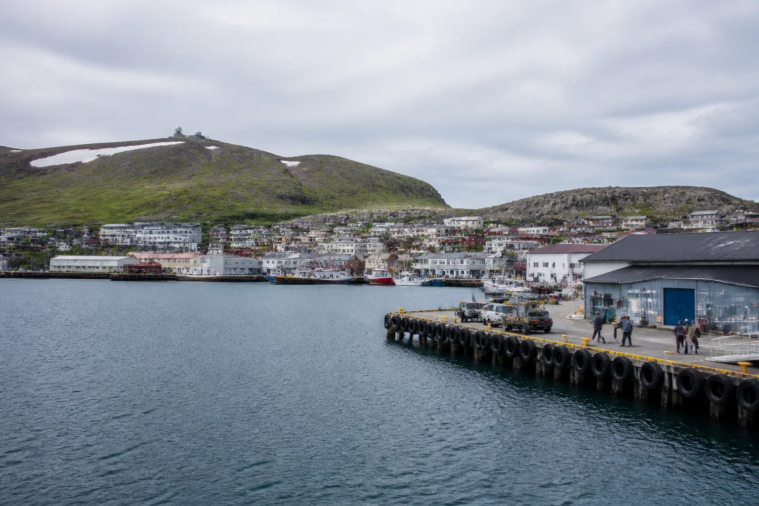 Representative cruise port destination view: Honningsvag, Norway; passenger waterfront and harbor water, not an exact landmark photograph.