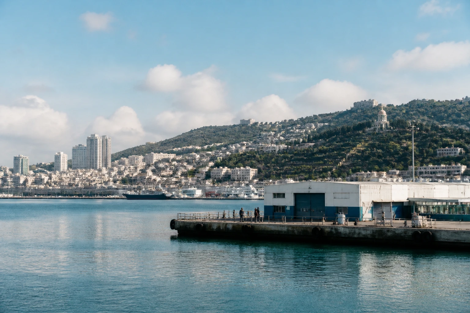 Representative cruise port destination view: Haifa, Israel; passenger waterfront and harbor water, not an exact landmark photograph.
