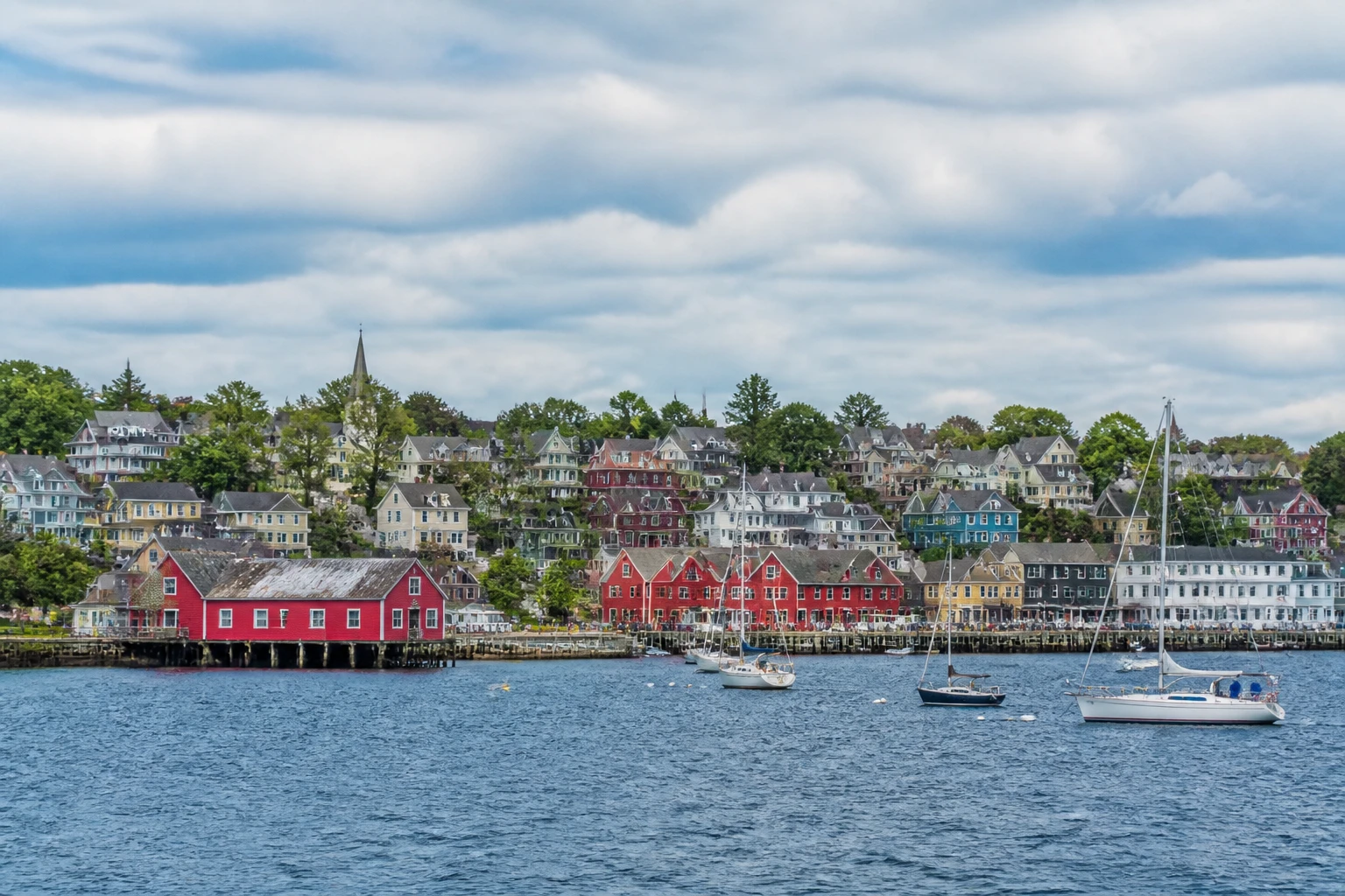 Representative cruise port destination view: Lunenburg, Canada; passenger waterfront and harbor water, not an exact landmark photograph.