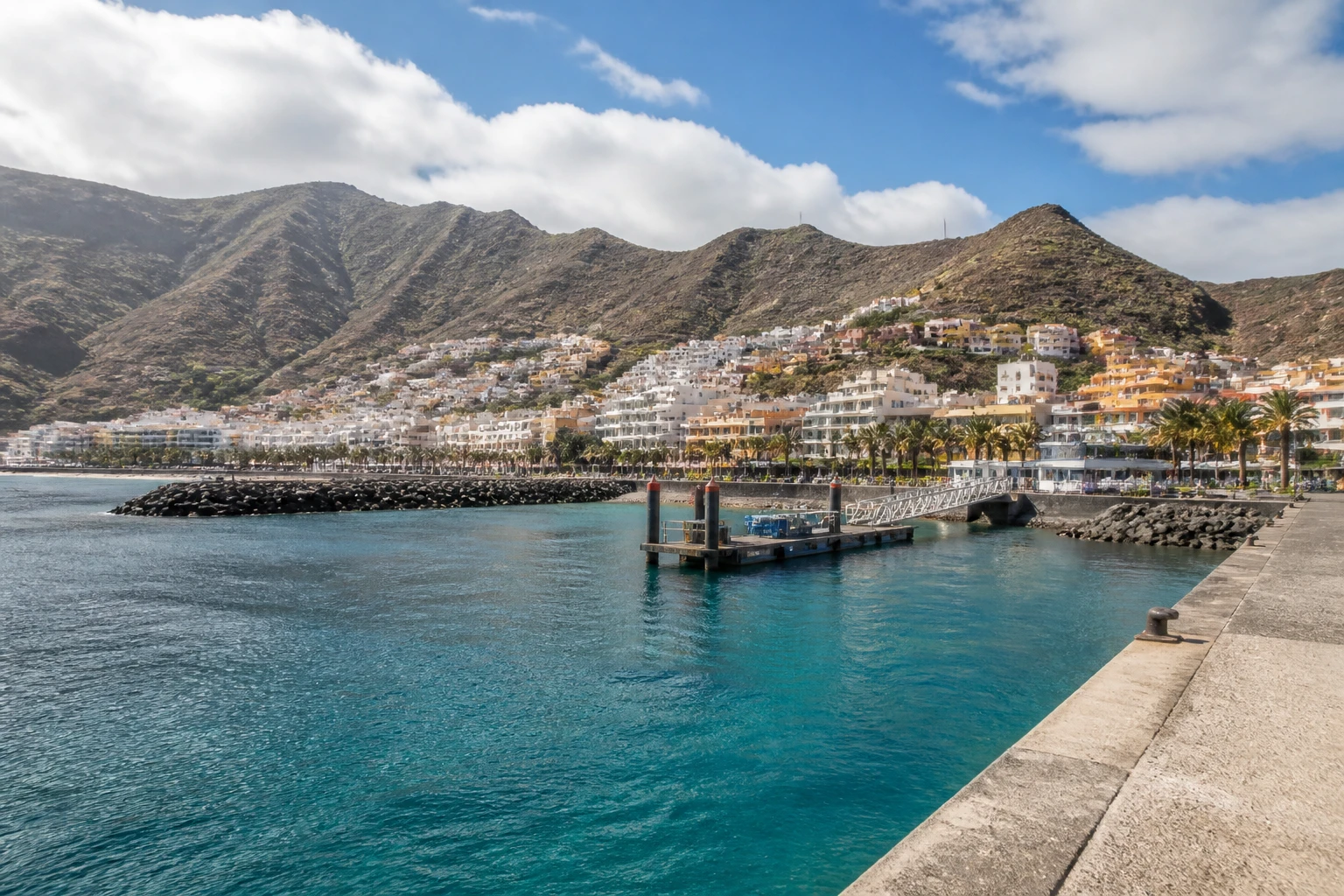 Representative cruise port destination view: San Sebastián De La Gomera, Spain; passenger waterfront and harbor water, not an exact landmark photograph.