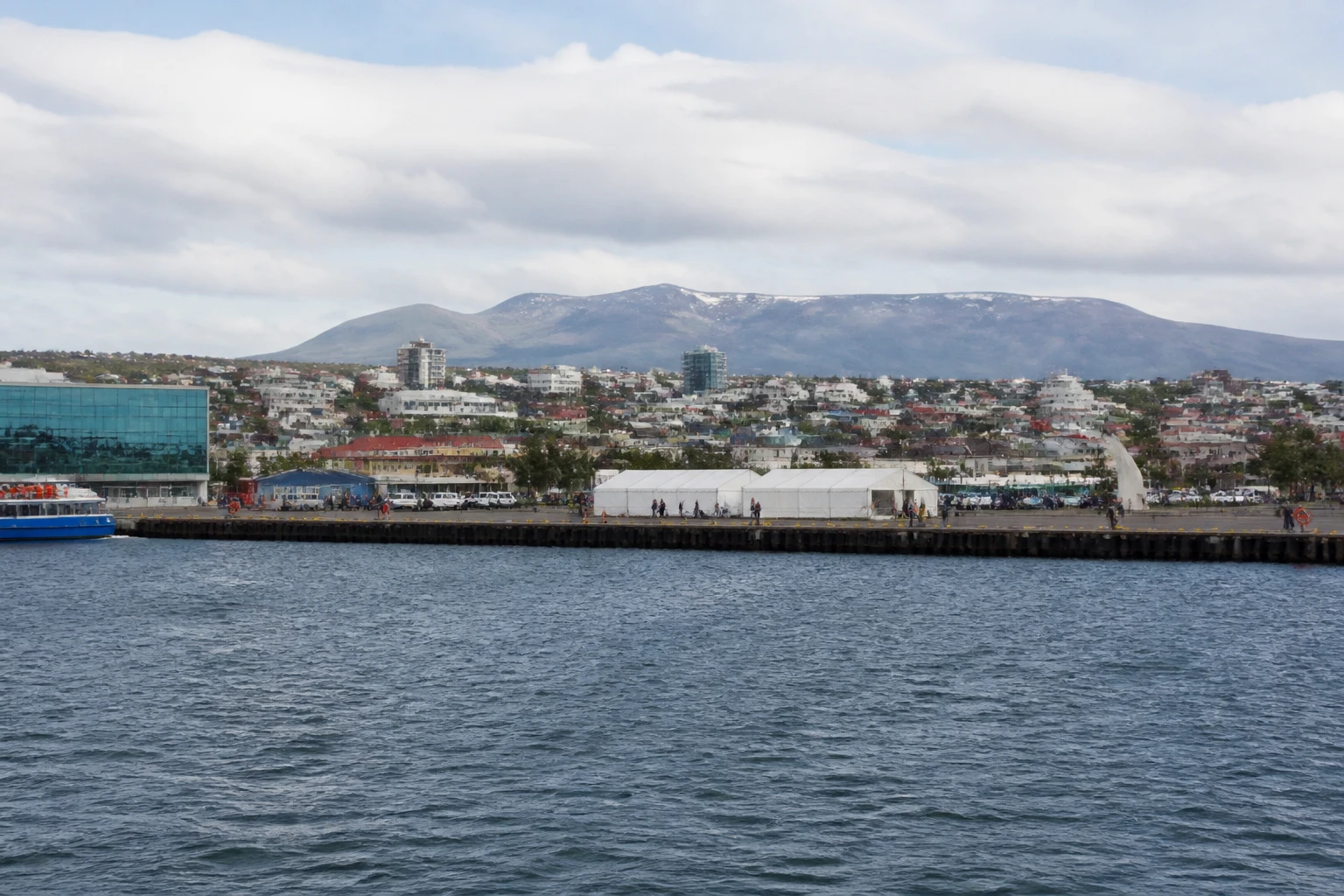 Representative cruise port destination view: Punta Arenas, Chile; passenger waterfront and harbor water, not an exact landmark photograph.