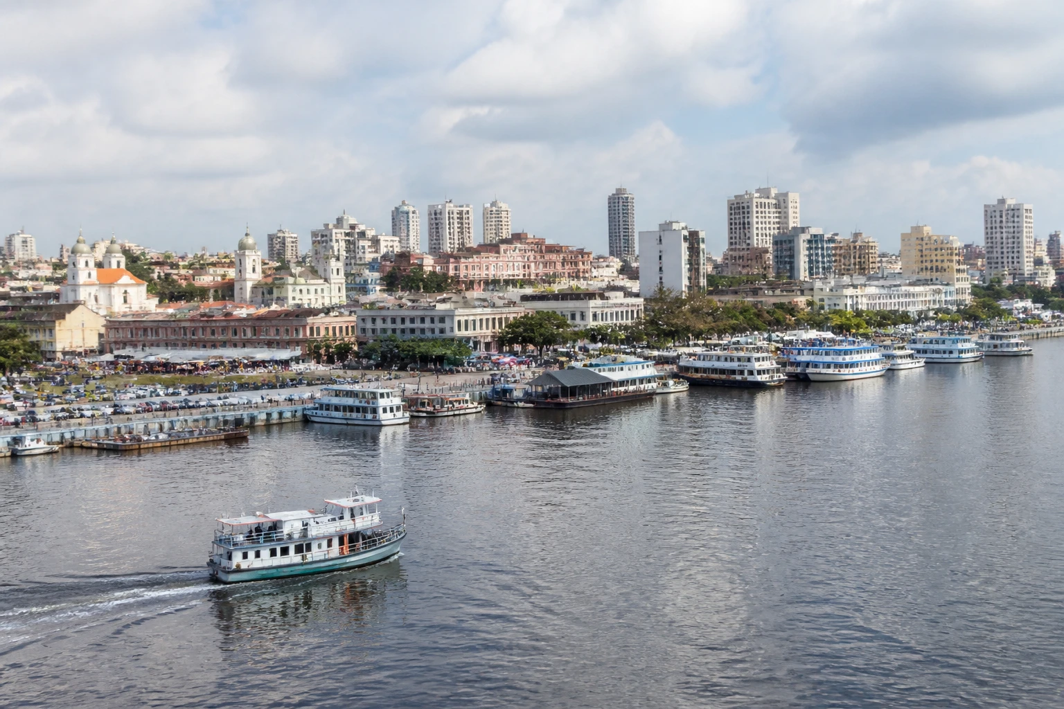Representative cruise port destination view: Manaus, Brazil; passenger waterfront and harbor water, not an exact landmark photograph.