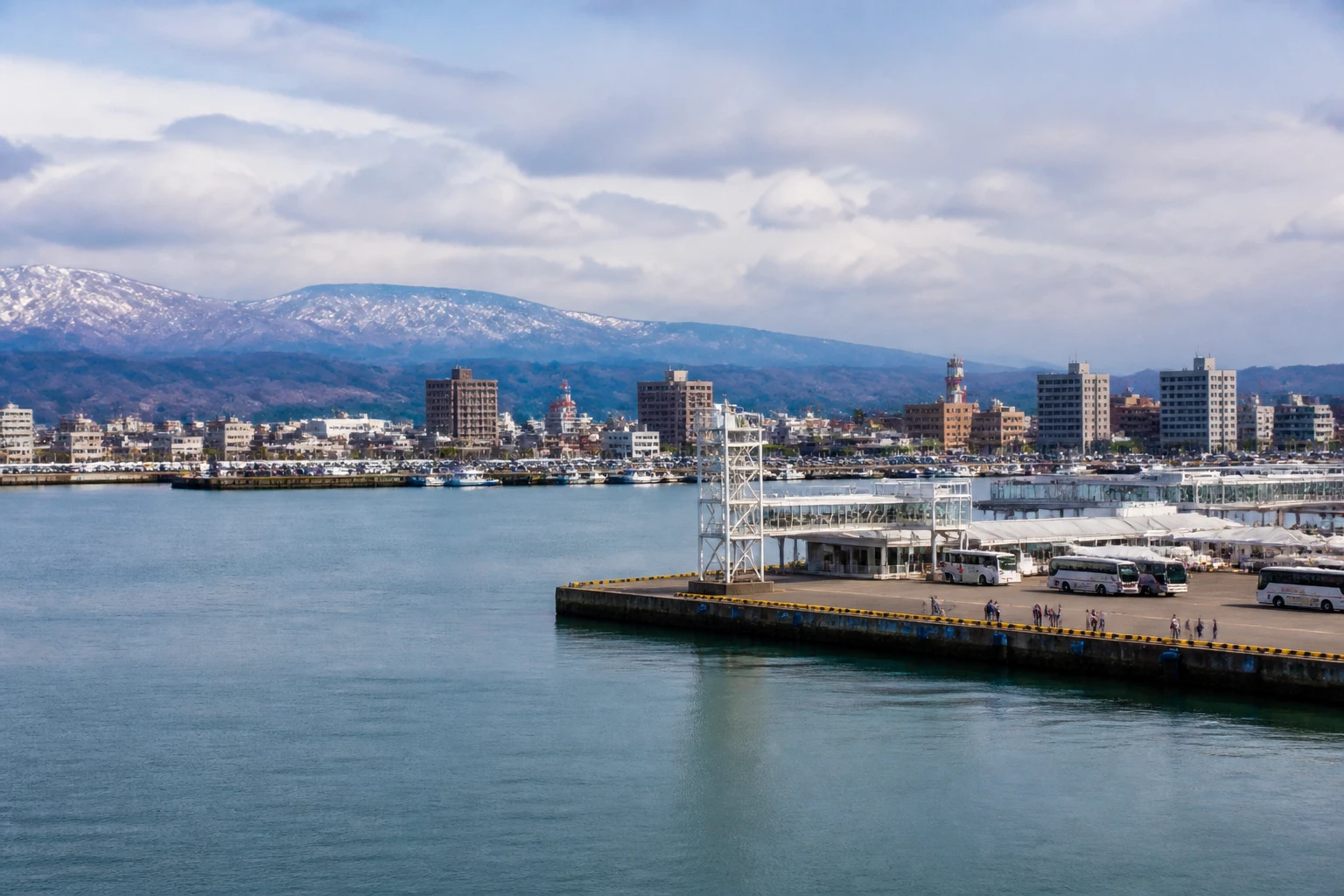 Representative cruise port destination view: Akita, Japan; passenger waterfront and harbor water, not an exact landmark photograph.