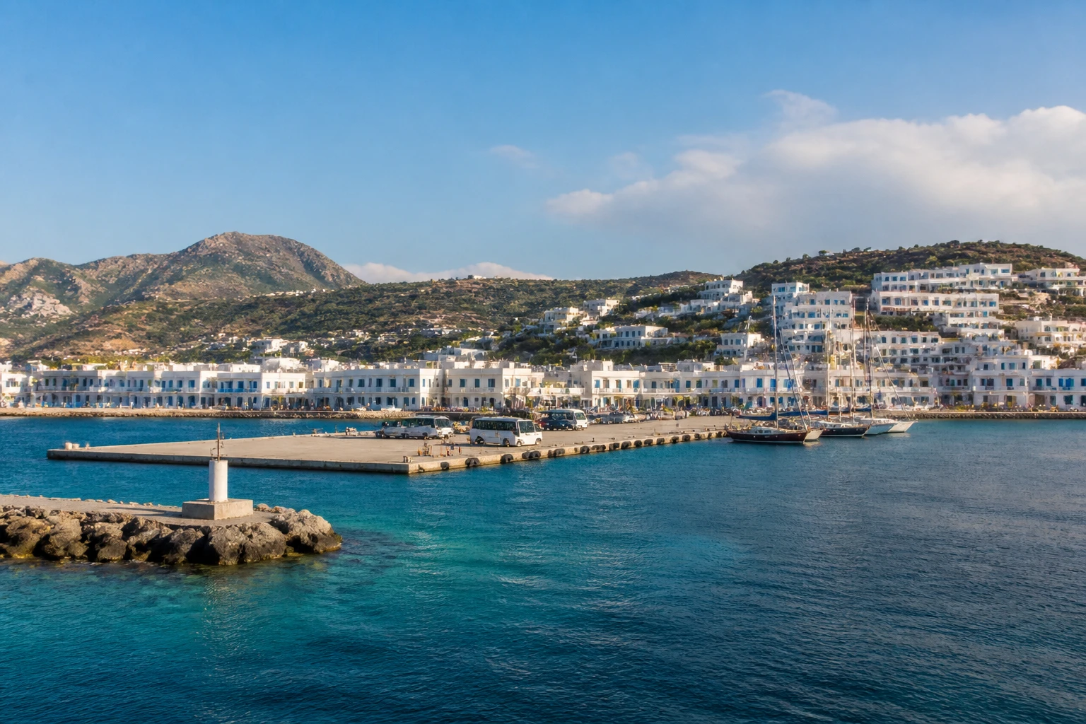 Representative cruise port destination view: Milos, Greece; passenger waterfront and harbor water, not an exact landmark photograph.