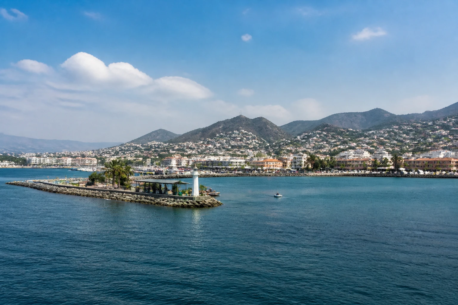 Representative cruise port destination view: Manzanillo, Mexico; passenger waterfront and harbor water, not an exact landmark photograph.