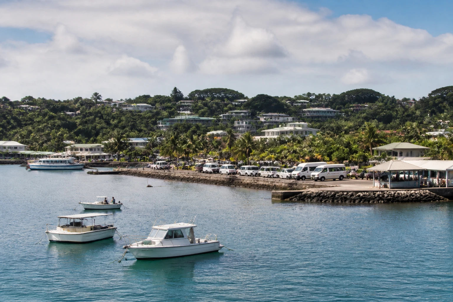 Representative cruise port destination view: Champagne Bay, Vanuatu; passenger waterfront and harbor water, not an exact landmark photograph.