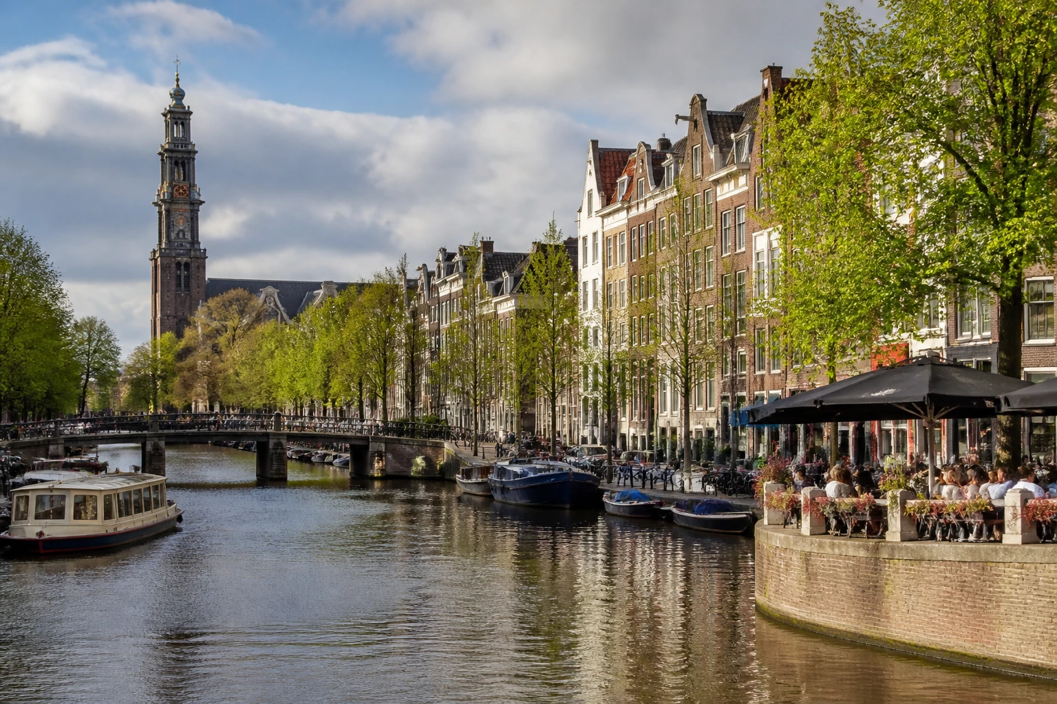 Representative city destination view: Amsterdam, Netherlands; passenger waterfront and harbor water, not an exact landmark photograph.