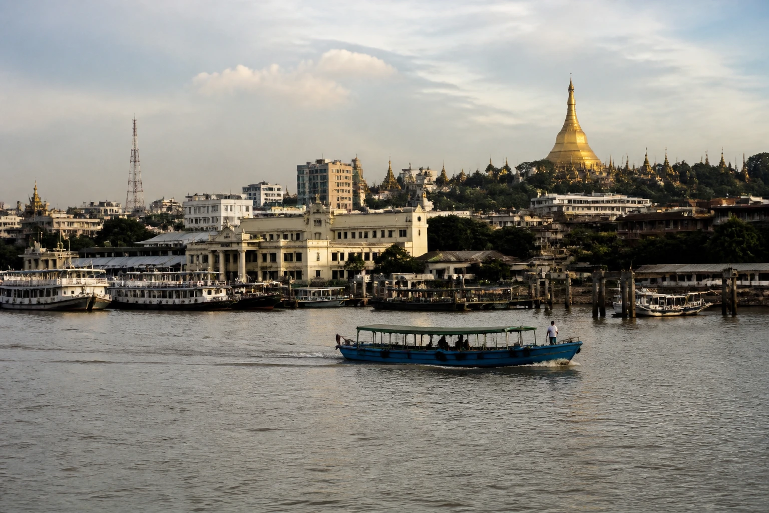 Representative cruise port destination view: Yangon, Myanmar; passenger waterfront and harbor water, not an exact landmark photograph.