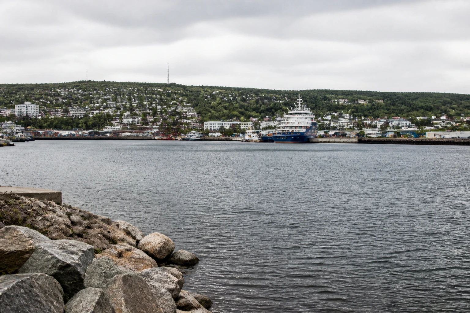 Representative cruise port destination view: Sept-Iles, Canada; passenger waterfront and harbor water, not an exact landmark photograph.