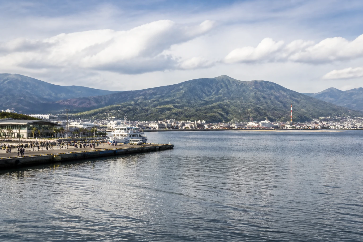 Representative cruise port destination view: Shimizu, Japan; passenger waterfront and harbor water, not an exact landmark photograph.
