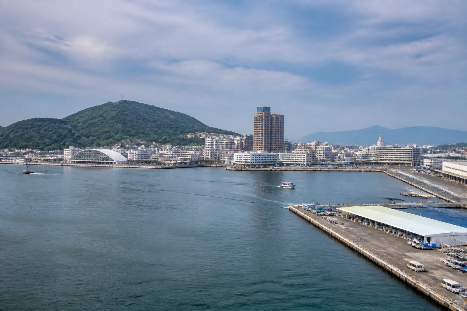 Representative cruise port destination view: Takamatsu, Japan; passenger waterfront and harbor water, not an exact landmark photograph.