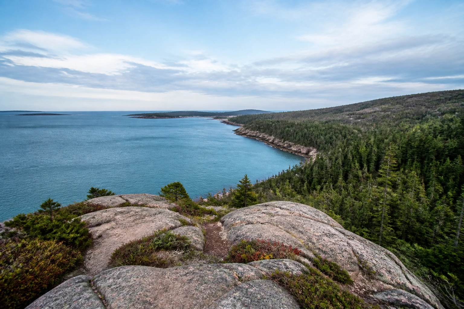 Representative national park destination view: Bar Harbor and Acadia National Park, United States; protected terrain and native vegetation, not an exact landmark photograph.