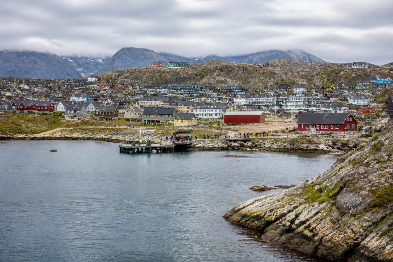 Representative cruise port destination view: Qaqortoq, Greenland; passenger waterfront and harbor water, not an exact landmark photograph.