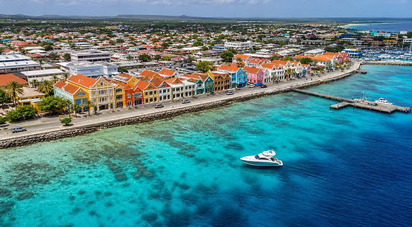 Aerial view of Kralendijk's colorful waterfront and clear blue Caribbean water in Bonaire