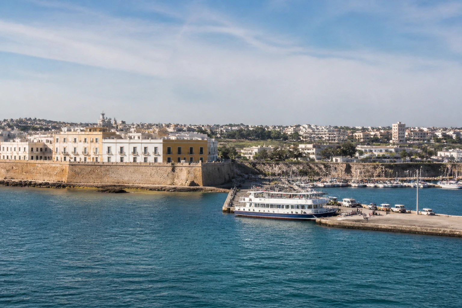Representative cruise port destination view: Gallipoli, Italy; passenger waterfront and harbor water, not an exact landmark photograph.
