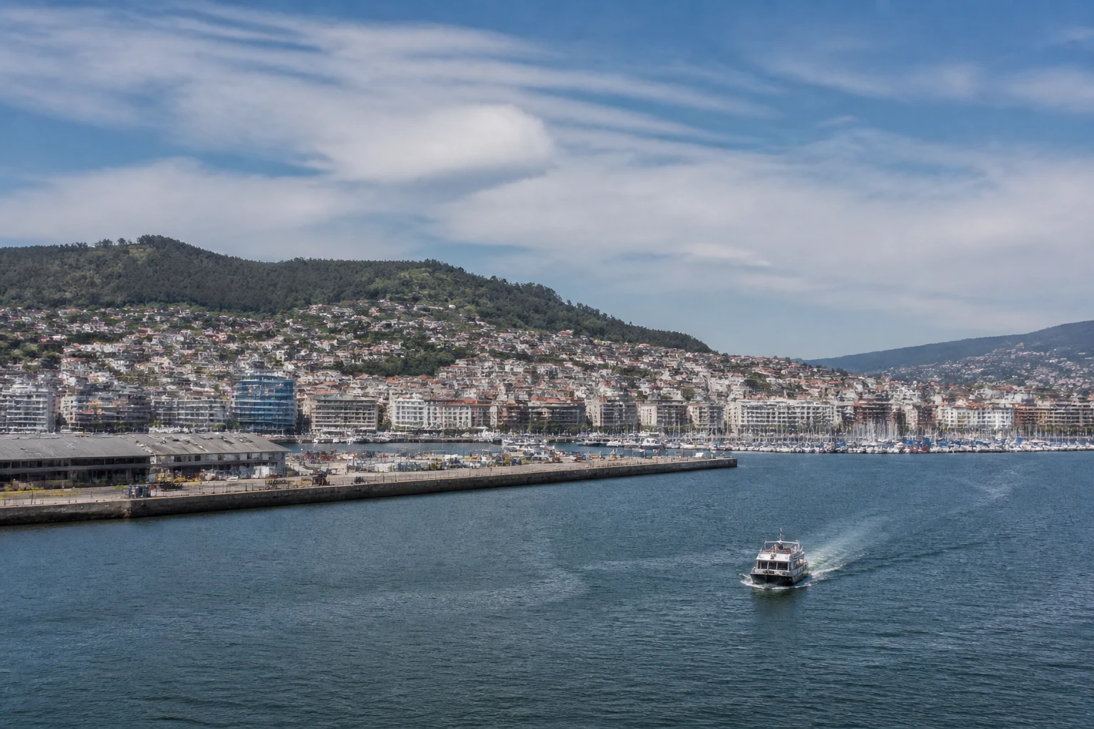 Representative cruise port destination view: Vigo, Spain; passenger waterfront and harbor water, not an exact landmark photograph.