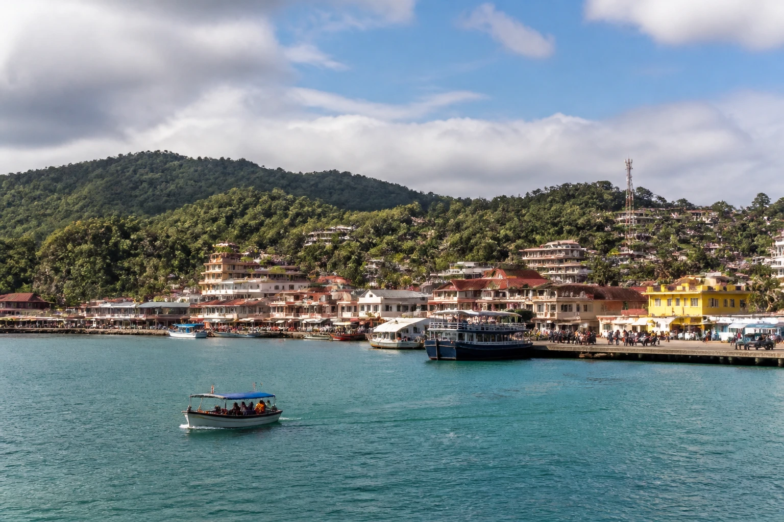 Representative cruise port destination view: Nosy Be, Madagascar; passenger waterfront and harbor water, not an exact landmark photograph.