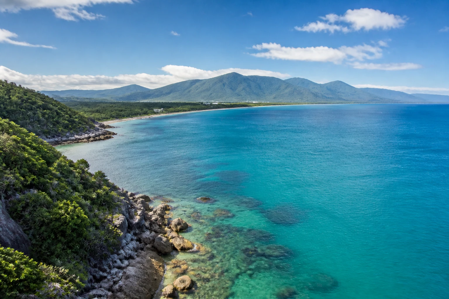 Representative coastal destination view: Cairns and the Great Barrier Reef, Australia; coastline and regional vegetation, not an exact landmark photograph.