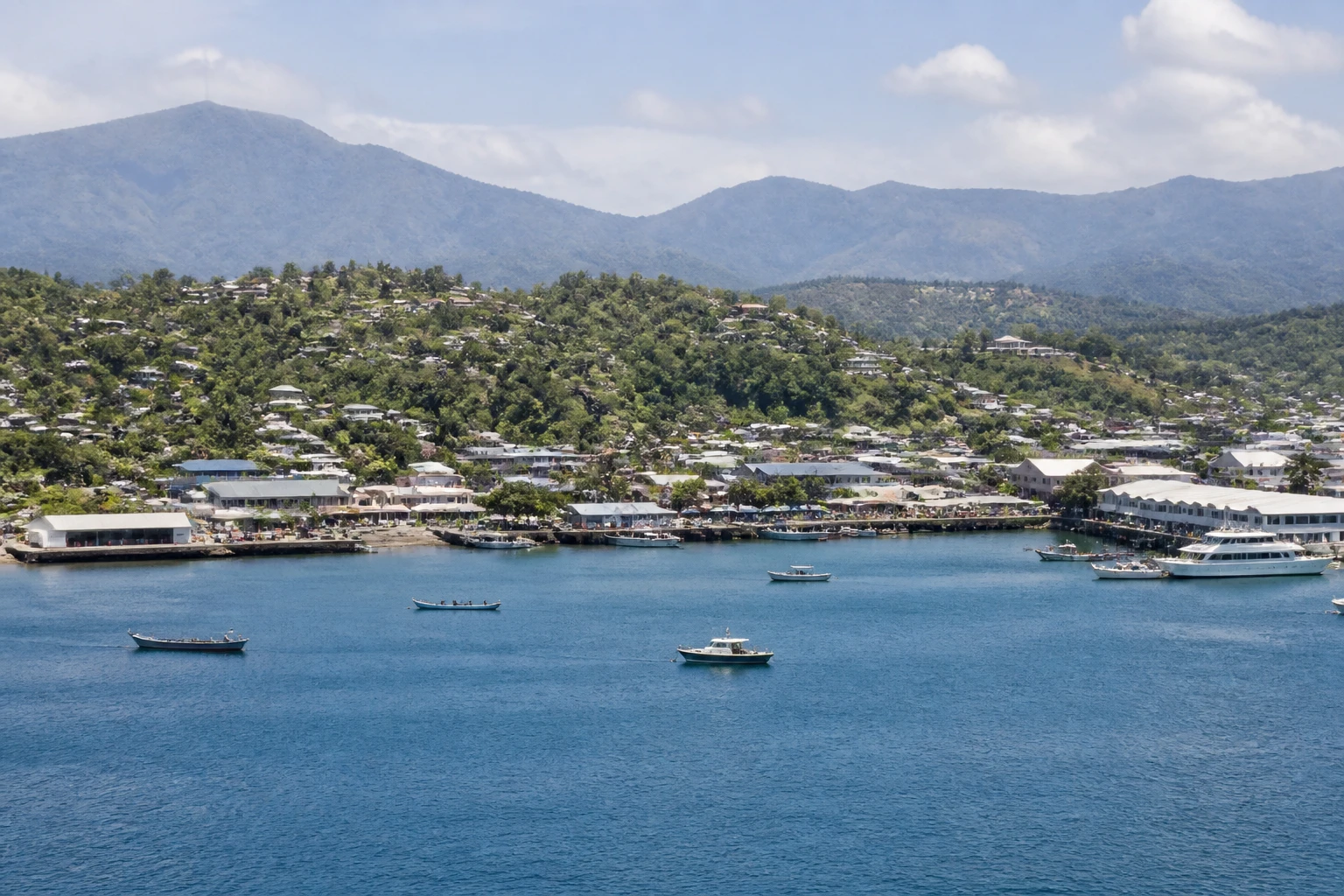 Representative cruise port destination view: Alotau, Papua New Guinea; passenger waterfront and harbor water, not an exact landmark photograph.