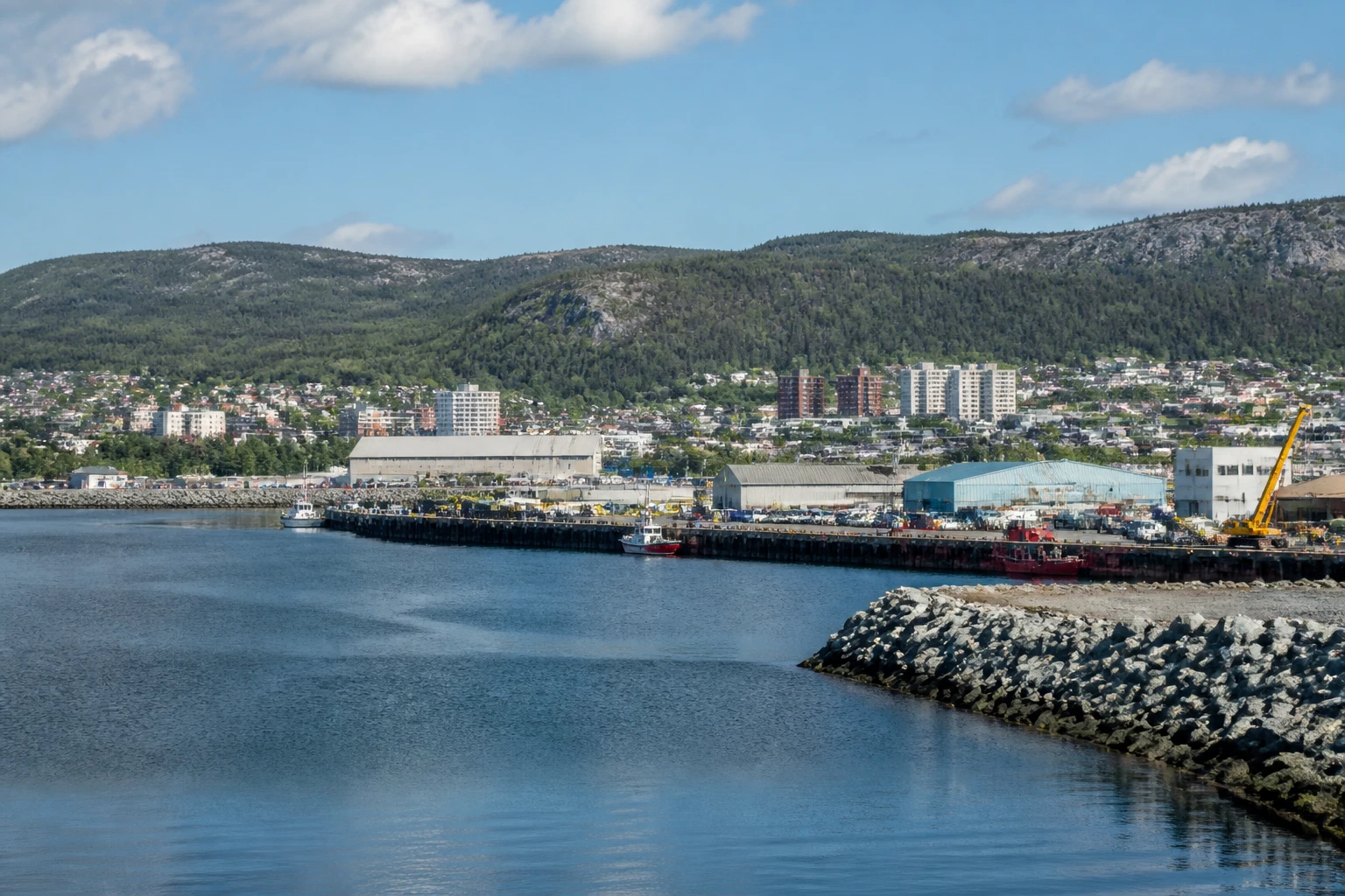 Representative cruise port destination view: Baie-Comeau, Canada; passenger waterfront and harbor water, not an exact landmark photograph.