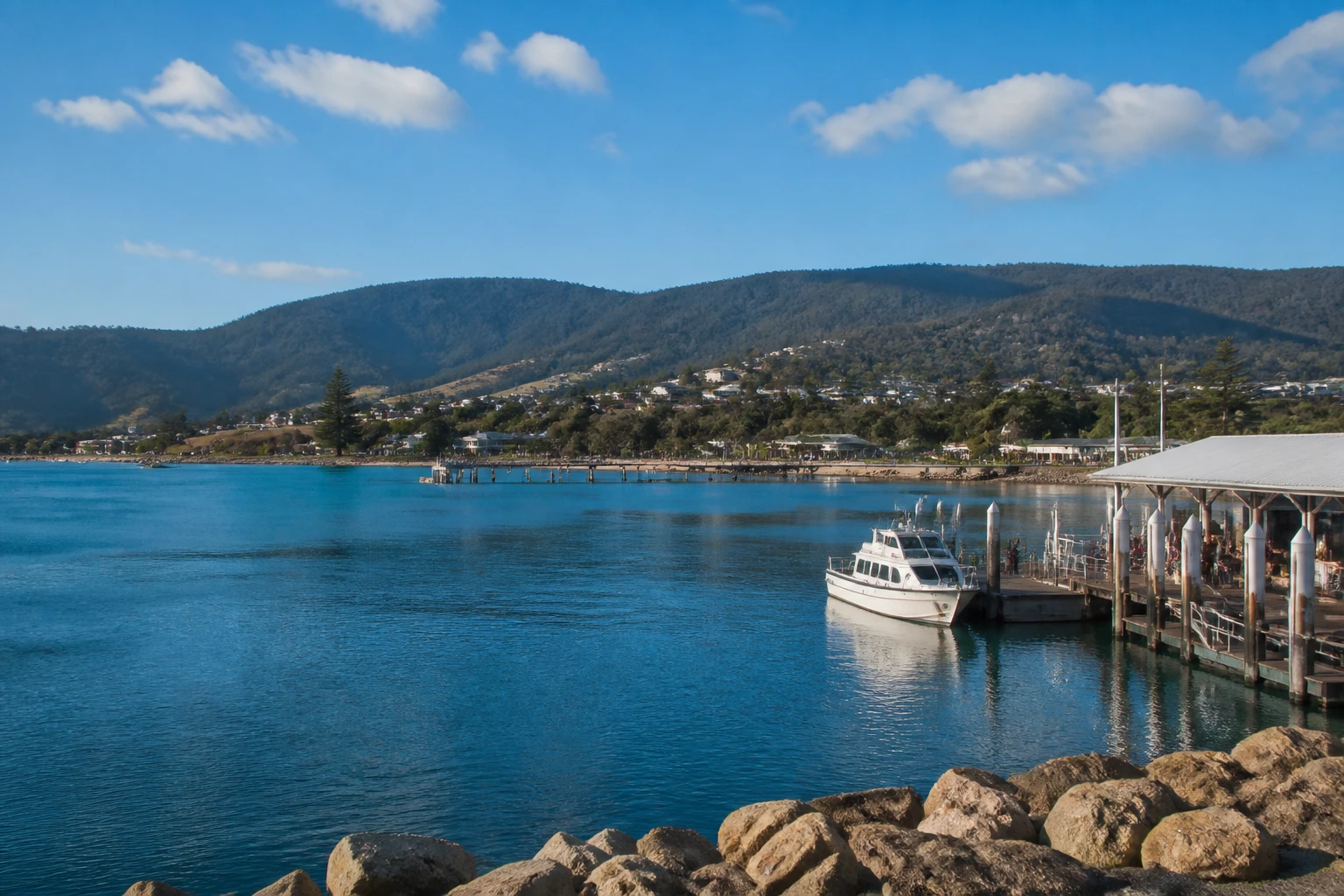 Representative cruise port destination view: Eden, Australia; passenger waterfront and harbor water, not an exact landmark photograph.